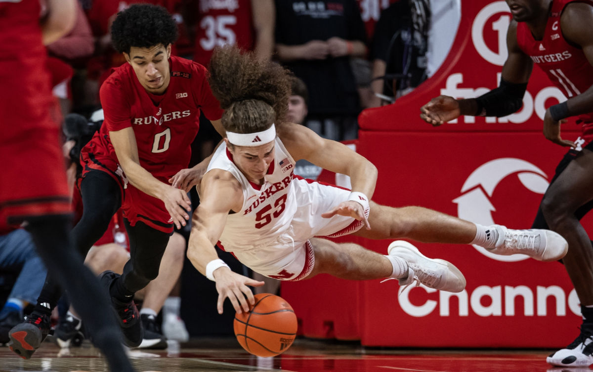 Nebraska's Josiah Allick dives for a loose ball against Rutgers' Derek Simpson on March 3, 2024, on Senior Day in Lincoln.